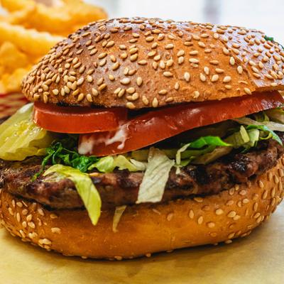 Hamburger with fries and avocado.