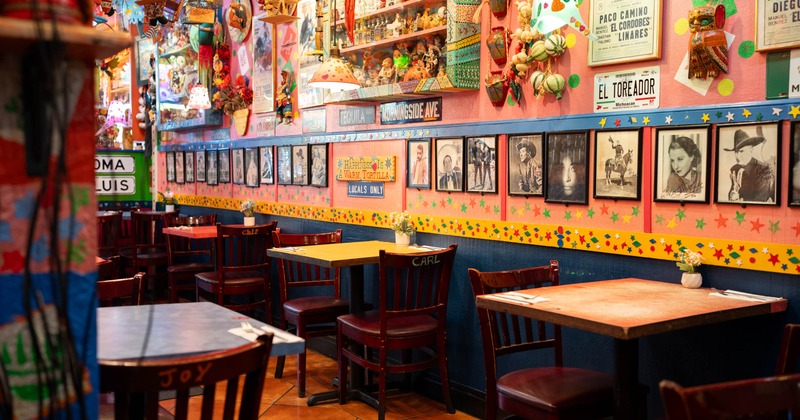 Interior of a colorful, decorated walls and wooden tables and chairs