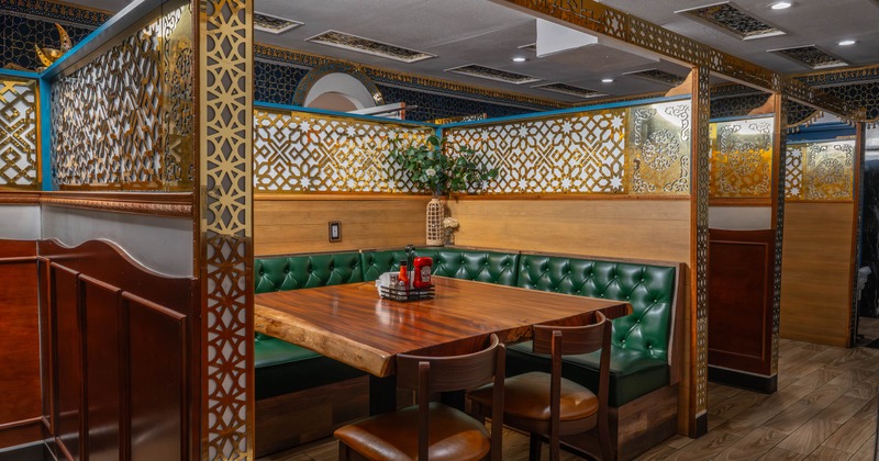Interior, dining area, large ''U'' shaped seating booth with live edge wooden table and chairs