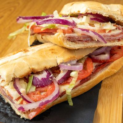 Italian hoagie sandwich with cured meats, provolone cheese, onions, tomatoes and lettuce.