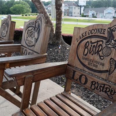 Outdoors, Wooden Adirondack chairs branded with the logo for the Lake Oconee Bistro.