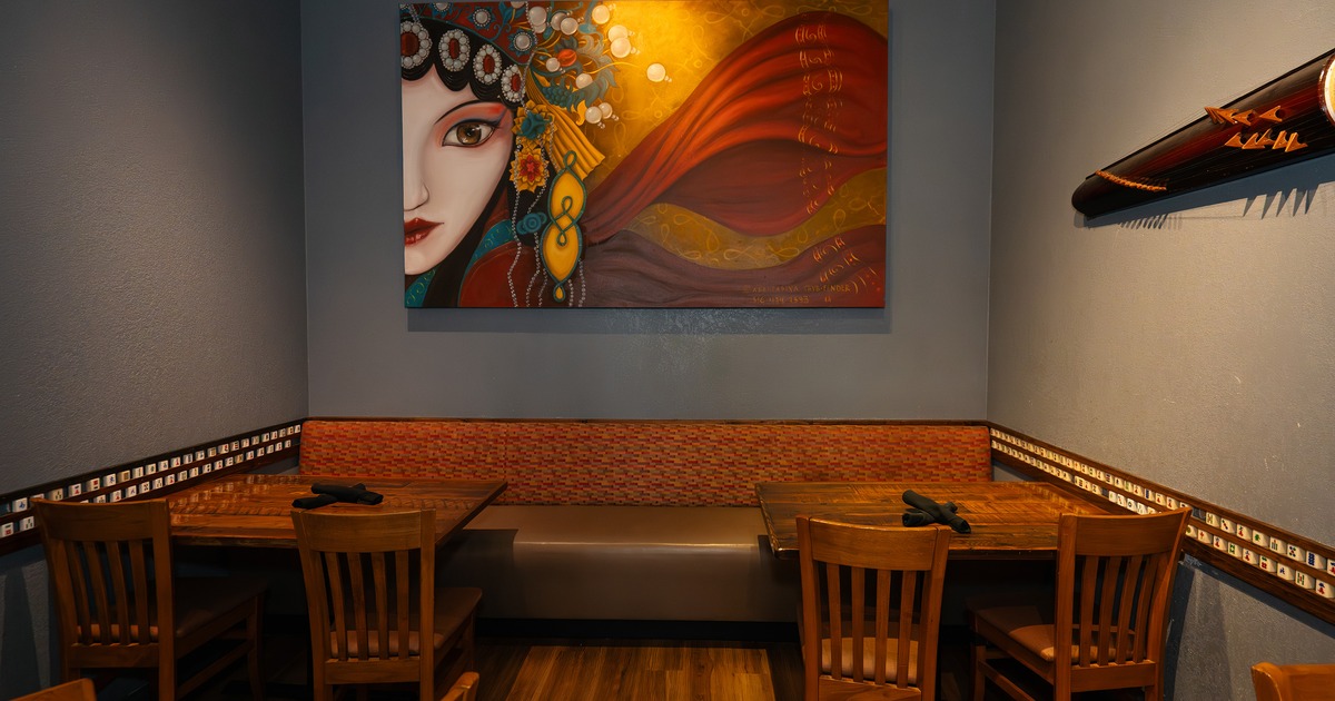 Cozy dining area corner with upholstered seat and wooden tables and chairs