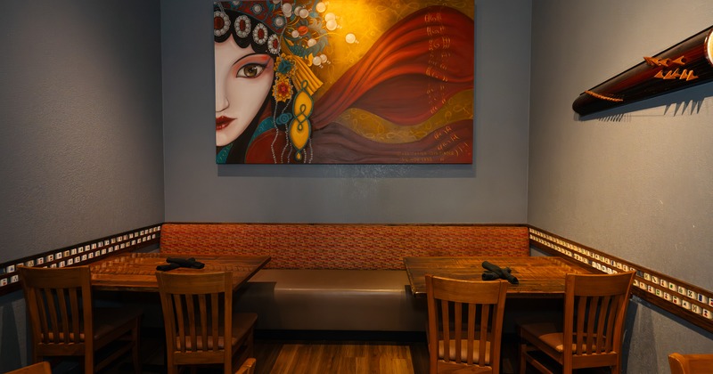 Cozy dining area corner with upholstered seat and wooden tables and chairs