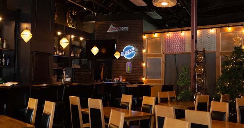 Interior, tables and chairs, bar in the back