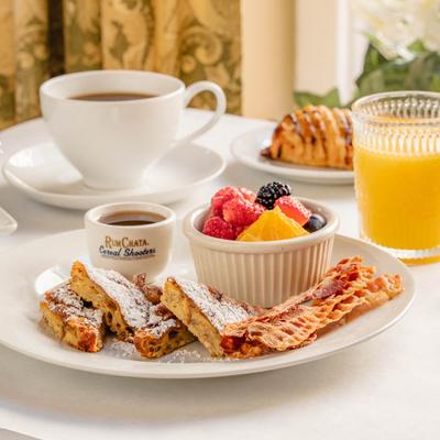 French toast, served with bacon and fresh fruit.