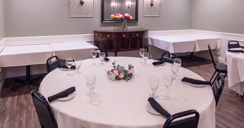 Private dining room, elegant round table set for six guests, close up