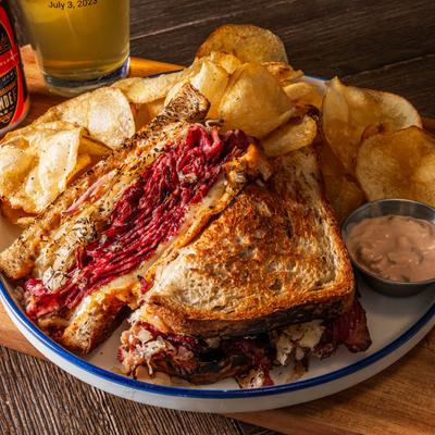 Hammock Reuben on marble rye bread, served with dressing and chips.