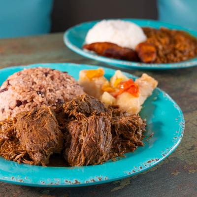 Cuban-style mojo marinated and slow-cooked pork served with rice and beans.