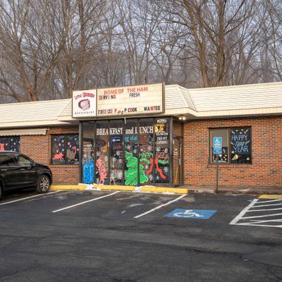 Diner exterior with with entrance and signage.