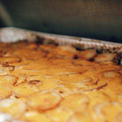 Baked potato dish in a large tin tray.