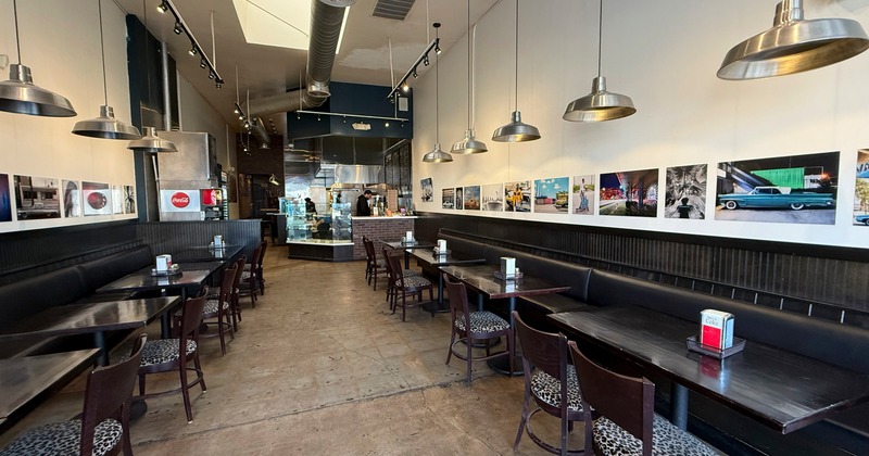 Interior, dining space with leather benches and art on the walls