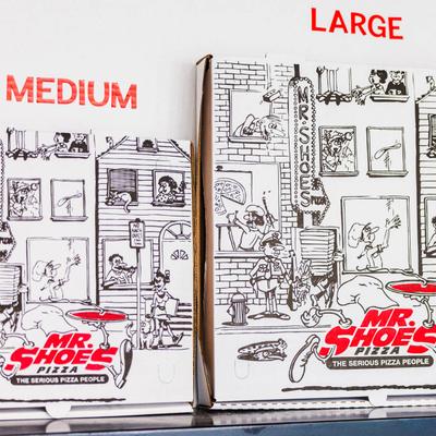 Two illustrated pizza boxes with the restaurant's logo.