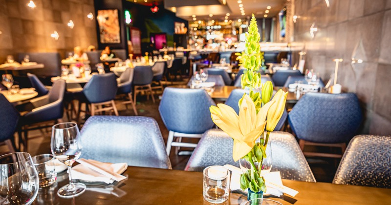 Diner area, tables and chairs, flowers in front