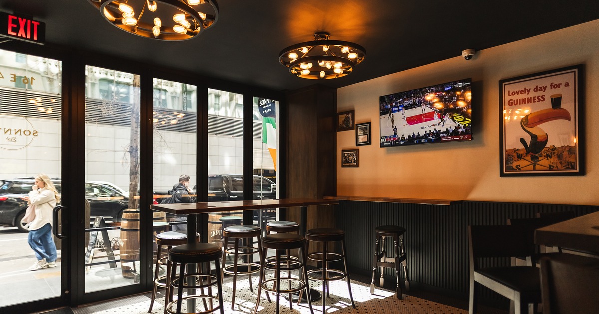 Sports bar interior space with high table and stools by the windows
