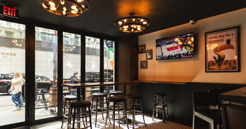 Sports bar interior space with high table and stools by the windows