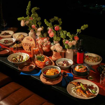 Table filled with assorted dishes and flowers.