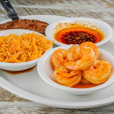 Steak and Shrimp served with mariachi butter, garlic butter and Mexican rice.