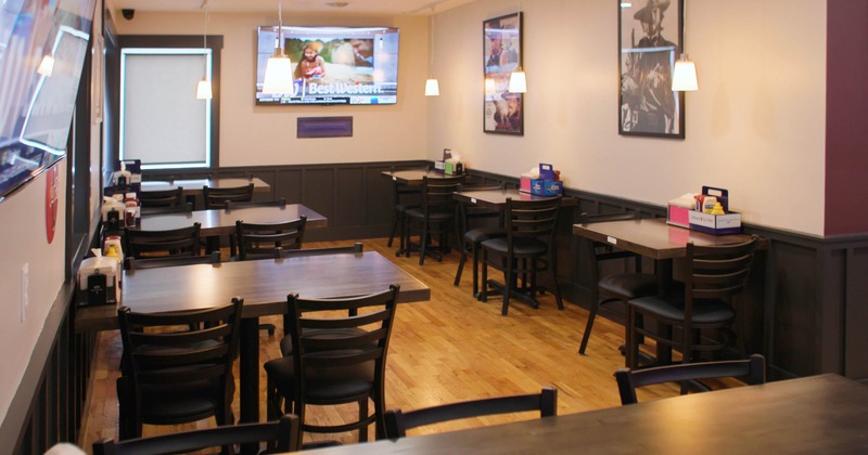 Small, cozy restaurant interior with wooden tables and chairs