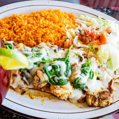 Grilled chicken, topped with shrimp, mushrooms, spinach, and mozzarella, served with rice and salad.