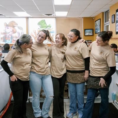 Staff members standing together inside a diner.