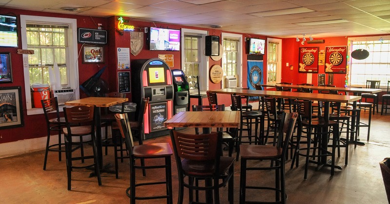 Interior, tall tables and bar chairs, decorated walls