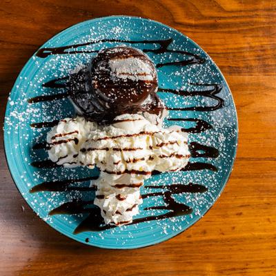Chocolate Lava Cake, with vanilla ice cream, chocolate drizzle, and whipped cream.