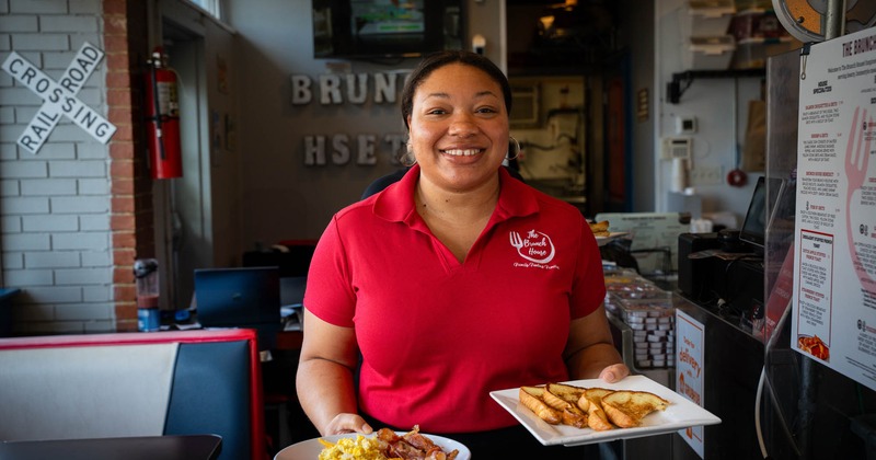 A staff member carrying food
