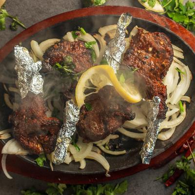 Marinated bone-in meat chops cut from the animal's rib