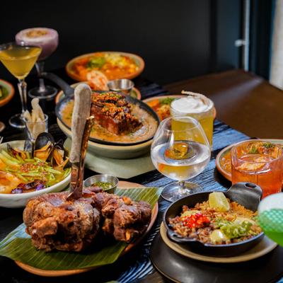 Table filled with assorted dishes and cocktails.