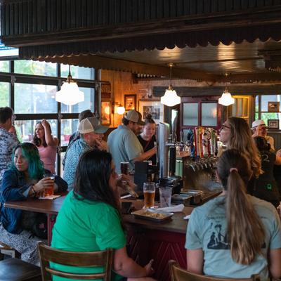 Customers at the bar having food and drinks.