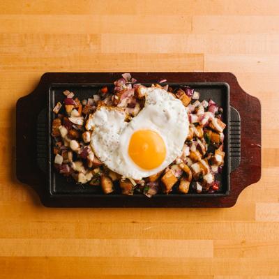 Sizzling sisig topped with a fried egg.