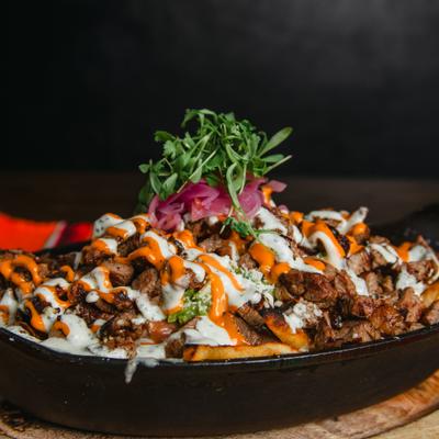 Loaded fries, with ribeye, beans, cheese, sour cream, and guacamole.