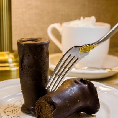 Chocolate desserts served on ythe table with a hot beverage.