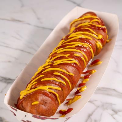 Hot Dog topped with a drizzle of mustard and ketchup.