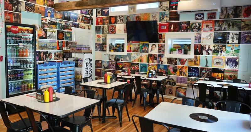 Nicely done interior dining area decorated with old album covers on the walls