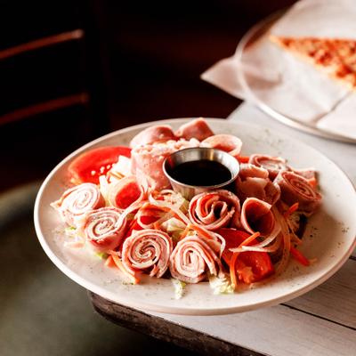 Antipasto Salad with ham, salami, capicola, fresh vegetables, cheese and dressing.