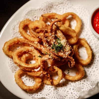 Fried Calamari served with marinara sauce, close-up.