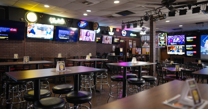 Interior, lined up tables with stools