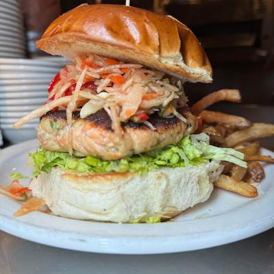 Salmon burger topped with ginger slaw and served with fries.