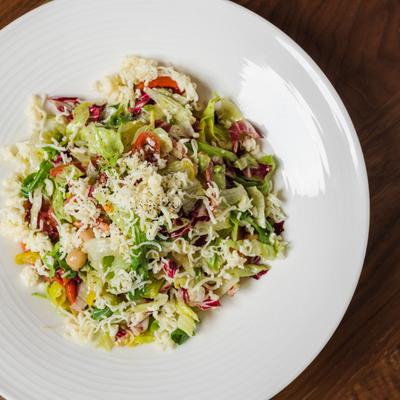 Salad, with mixed greens, chickpeas, peppers, tomatoes, lettuce, and shredded cheese