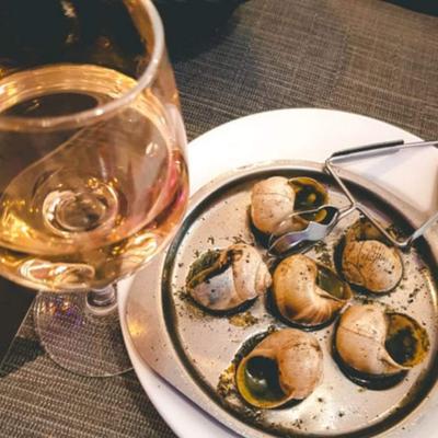 Escargot, with butter, fresh herbs, garlic, and goat cheese cream sauce