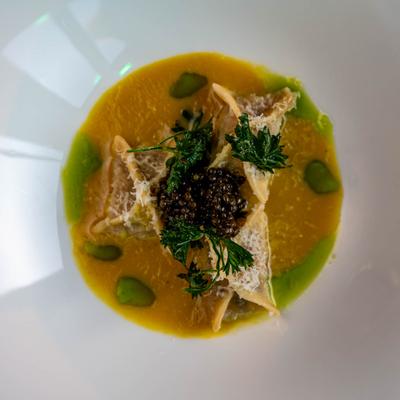 Agnolotti pasta, stuffed with clams, with apple sauce, fermented mushrooms, and caviar.