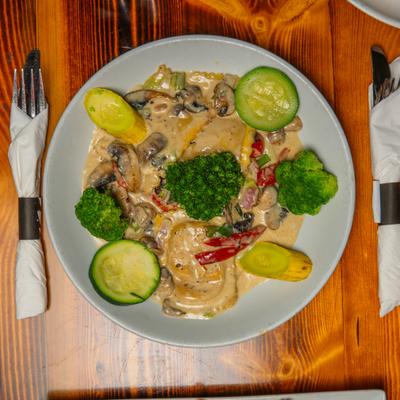 Lobster Ravioli with veggies and cream sauce.