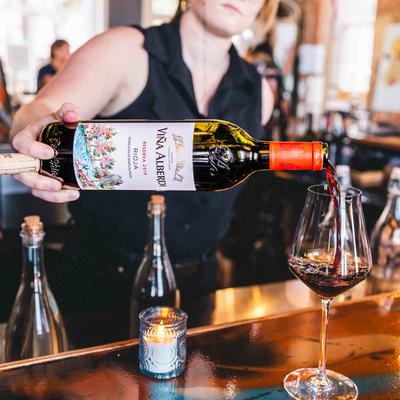 A person pouring wine.