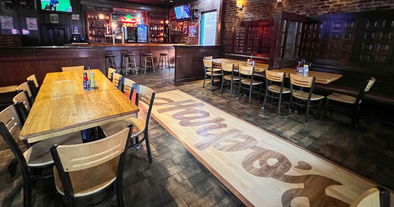 Seating area, a bar in the back, booths on the right