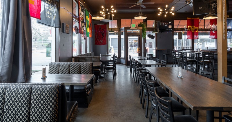 Spacious and cozy interior seating area with upholstered booths, tables and chairs