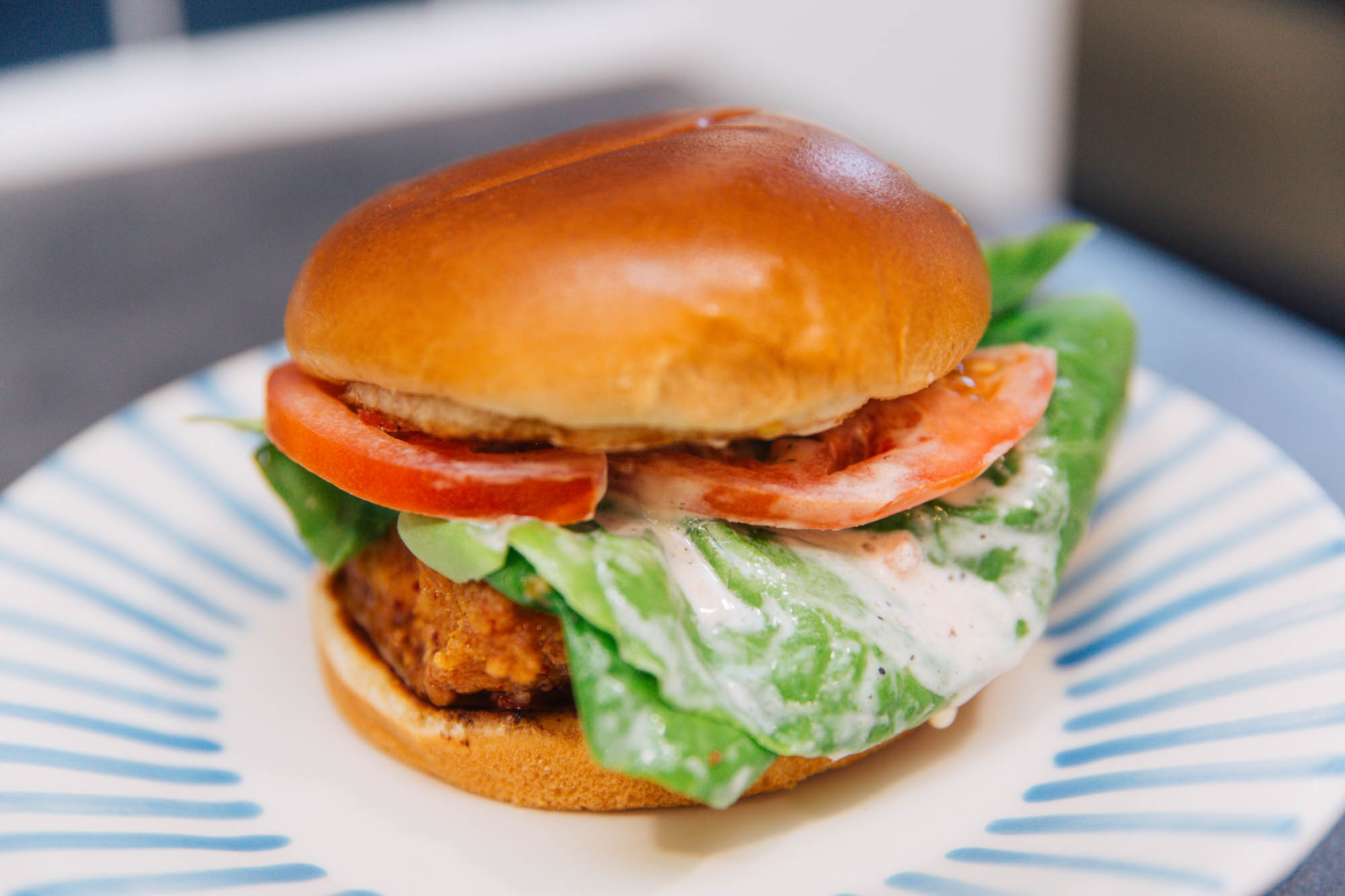 Fried chicken sandwich with lettuce and tomato