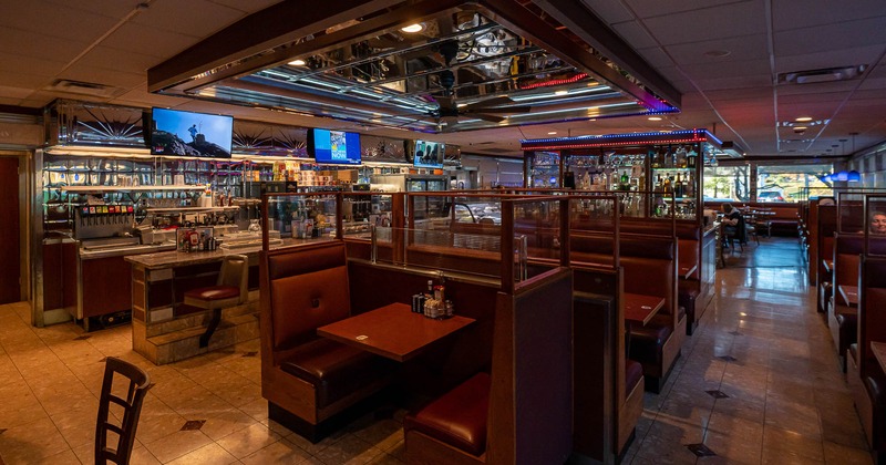 Private booths with bar in the background