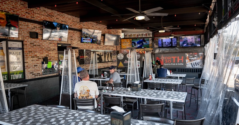 Covered patio with tables and chairs