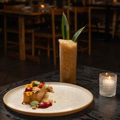 Creatively presented dessert served on the table with a cocktail.